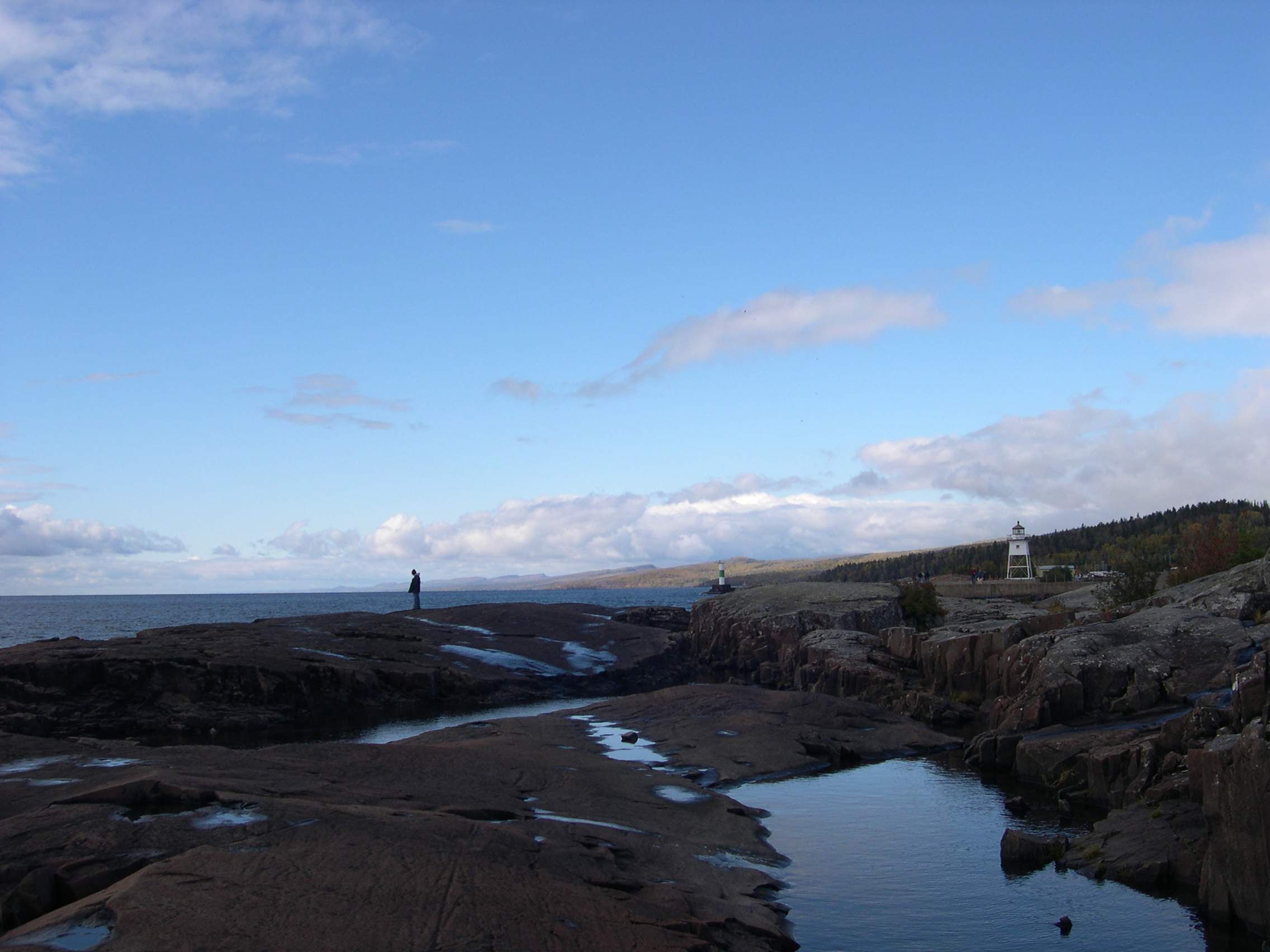 A boy on the rocks overlooking Lake Superior in Grand Marais, Minnesota